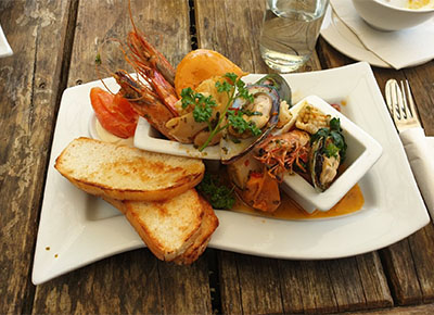 Bread, shrimps, fish plated at Lakeland Restaurant Tokaanu