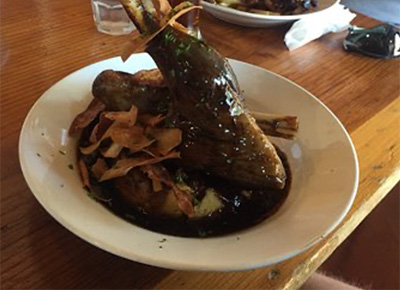 A lamb shank covered in gravy at Schnapps Bar National Park Village