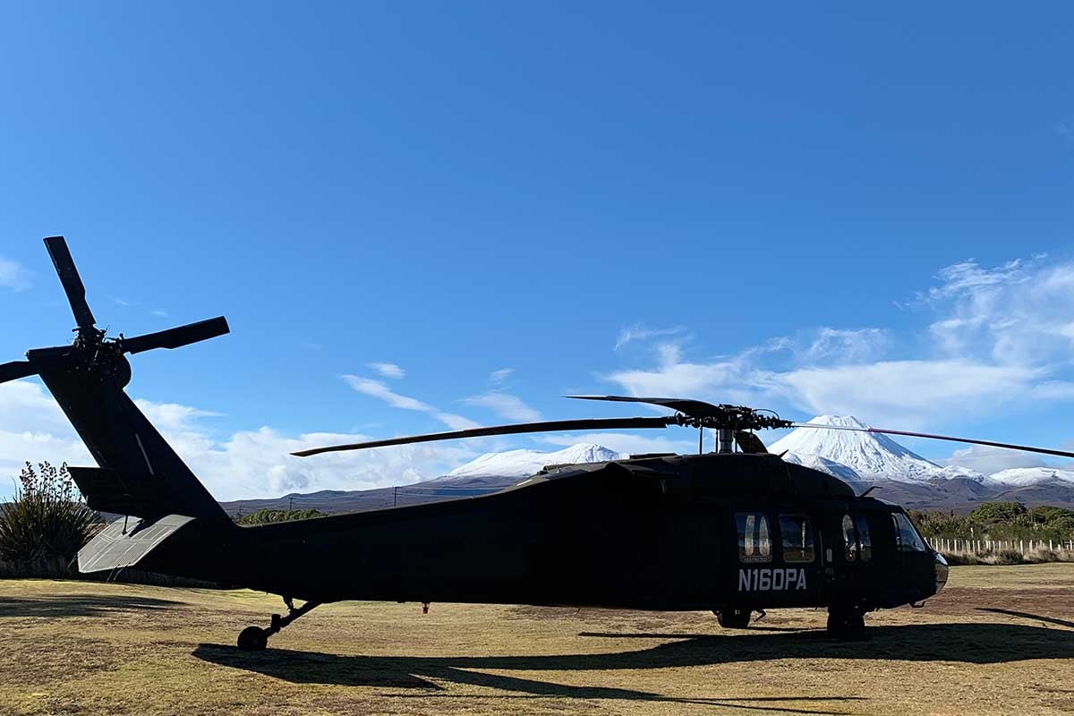 Kahu Blackhawk with snow-capped Mt Ngauruhoe at Discovery helipad Tongariro
