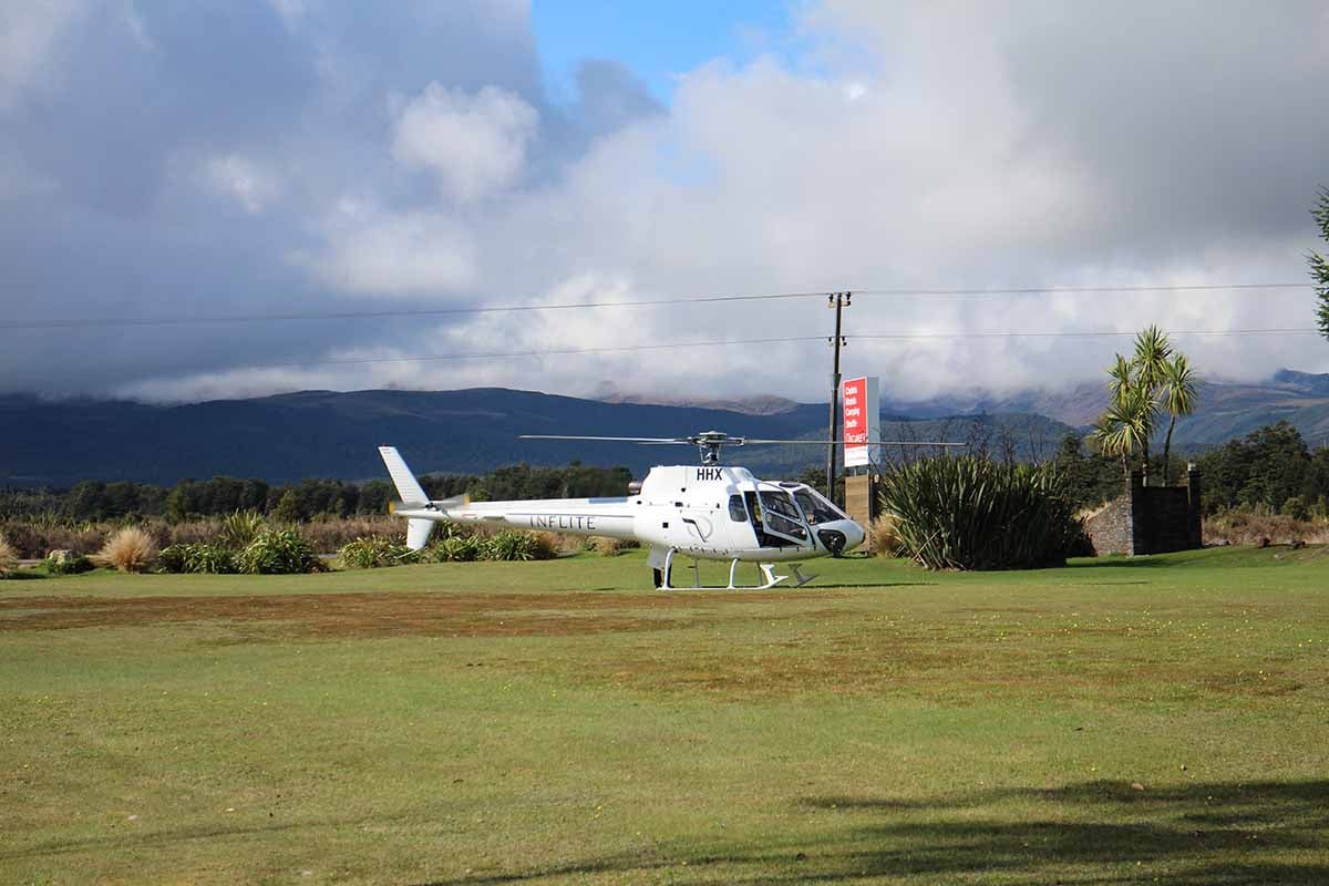 Inflite ZK-HHX at Discovery Helipad with foothills of Mt Ruapehu