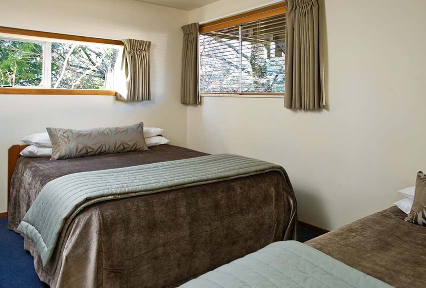 Queen and single bed in seperate bedroom of motel one bedroom at Discovery Lodge Tongariro