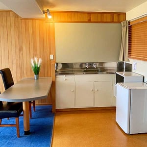 Discovery Lodge Tongariro Kitchenette with fridge, microwave, sink and table