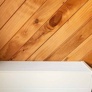 Modern central heating radiator on a timber wall 