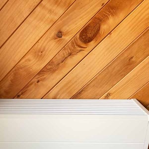 Modern central heating radiator on a timber wall