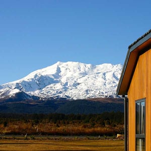 Discovery chalet with snow capped Mt Ruapehu in the background