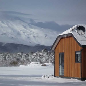 Exterior of a Discovery Lodge chalet with snow covering the ground