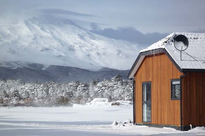 Discovery Chalet amongst snow with Mt Ruapehu
