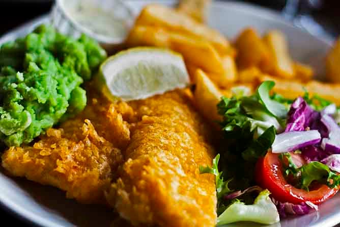 Fish and chips with salad and a piece of lemon