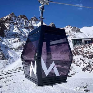 A Sky Waka gondola cabin with Knoll Ridge Cafe in the background at Whakapapa Mt Ruapehu