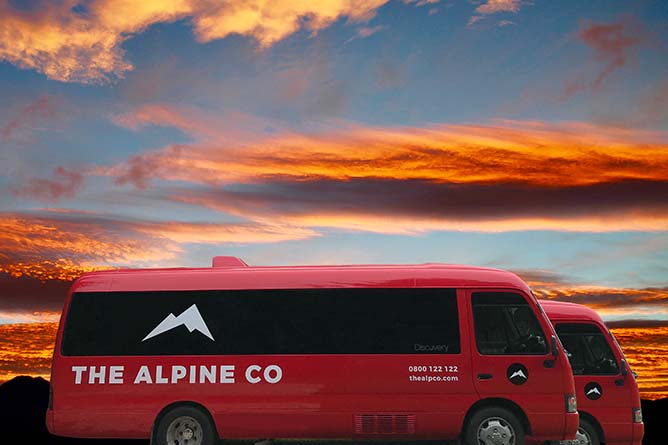 The Apline Co's early Tongariro Crossing shuttle buses owned and operated by Discovery Lodge with beautiful sunrise